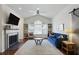 Bright living space with a fireplace, hardwood floors, natural light, and stylish decor at 7104 Woodland Ln, Alpharetta, GA 30009