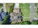 An aerial view reveals the home's roofline, spacious lawn, landscaping, driveway, and street access at 406 Whitmore Nw Dr, Atlanta, GA 30305