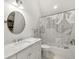 Clean bathroom with a vanity, bathtub with shower, and neutral tile at 406 Whitmore Nw Dr, Atlanta, GA 30305