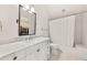Bright bathroom with a vanity, bathtub with shower, and neutral tile at 406 Whitmore Nw Dr, Atlanta, GA 30305