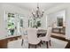 Light-filled dining room featuring French doors with a view of the landscaped yard at 406 Whitmore Nw Dr, Atlanta, GA 30305