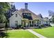 Charming home featuring a covered front porch with verdant landscaping and manicured lawn at 406 Whitmore Nw Dr, Atlanta, GA 30305