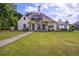 Charming home with lush landscaping, a stone walkway, and an inviting covered porch with pergola at 406 Whitmore Nw Dr, Atlanta, GA 30305