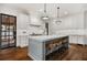 Bright kitchen featuring a large center island with a marble countertop and modern lighting at 406 Whitmore Nw Dr, Atlanta, GA 30305