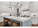 Bright kitchen featuring a large center island with a marble countertop and modern appliances at 406 Whitmore Nw Dr, Atlanta, GA 30305