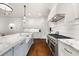 Bright kitchen featuring a large center island with a marble countertop and modern appliances at 406 Whitmore Nw Dr, Atlanta, GA 30305
