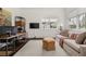 Bright living room featuring a desk, sofa, large windows, and a neutral color palette at 406 Whitmore Nw Dr, Atlanta, GA 30305