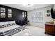 Bedroom featuring a black accent wall, a window with blinds, and a writing desk at 4630 Smokestone Dr, Douglasville, GA 30135