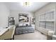 Bright bedroom with a gray bed, a modern desk, and built-in bookcases at 4630 Smokestone Dr, Douglasville, GA 30135