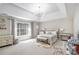Spacious bedroom with a tray ceiling, large windows, and neutral decor creating a serene and inviting space at 4630 Smokestone Dr, Douglasville, GA 30135