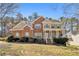 Charming two-story brick home with a welcoming front porch and well-manicured landscaping at 4630 Smokestone Dr, Douglasville, GA 30135