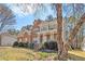 Two-story brick home featuring a covered front porch, mature trees, and an inviting curb appeal at 4630 Smokestone Dr, Douglasville, GA 30135