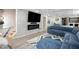 Stylish living room boasting a modern fireplace, a large TV, recessed lights, and a plush blue sectional at 4630 Smokestone Dr, Douglasville, GA 30135
