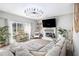 Bright living room with large windows, modern lighting, and a cozy fireplace feature at 4630 Smokestone Dr, Douglasville, GA 30135