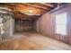 Unfinished basement featuring concrete floor, insulated ceiling, and a window at 1602 Allsworth Se Ct, Smyrna, GA 30082