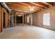 Unfinished basement with exposed ceiling, concrete floor, window, and framed doorway at 1602 Allsworth Se Ct, Smyrna, GA 30082