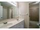 Bathroom featuring double sinks, a large mirror, and a view of the shower/tub at 1602 Allsworth Se Ct, Smyrna, GA 30082