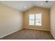 Cozy bedroom with neutral walls, carpet, and a window providing natural light at 1602 Allsworth Se Ct, Smyrna, GA 30082