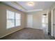 Bedroom with carpet, tray ceilings, natural lighting, and an open doorway at 1602 Allsworth Se Ct, Smyrna, GA 30082
