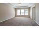 Bedroom with neutral walls, carpet, tray ceilings and three windows at 1602 Allsworth Se Ct, Smyrna, GA 30082