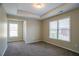 Bedroom with carpet, windows providing natural light, and a tray ceiling at 1602 Allsworth Se Ct, Smyrna, GA 30082