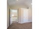 Hallway with carpeted floors, neutral paint, and an entry view with white doors at 1602 Allsworth Se Ct, Smyrna, GA 30082