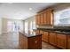 Modern kitchen showcasing island, granite countertops, wood cabinets, and gas cooktop at 1602 Allsworth Se Ct, Smyrna, GA 30082