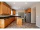 Spacious kitchen with granite countertops, wood cabinets, and stainless steel refrigerator at 1602 Allsworth Se Ct, Smyrna, GA 30082