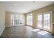 Bright, airy living room with large windows, French doors to deck, and tile flooring at 1602 Allsworth Se Ct, Smyrna, GA 30082