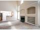 Bright living room with fireplace, built-in shelving, open to kitchen at 1602 Allsworth Se Ct, Smyrna, GA 30082