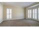 Inviting living room featuring neutral walls, carpeted floors, and abundant natural light at 1602 Allsworth Se Ct, Smyrna, GA 30082