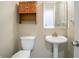 Small powder room features pedestal sink, mirror, and storage at 1602 Allsworth Se Ct, Smyrna, GA 30082