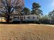 Charming single-story home with a stone accent entry, complemented by mature trees and a well-maintained lawn at 2326 Union Grove Ct, Lithonia, GA 30058