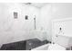 Beautiful bathroom with dark tile floor, glass shower and marble walls and surfaces at 4955 Day Lily Nw Way, Acworth, GA 30102