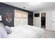 Bedroom with a dark accent wall, closet, and window providing a cozy and private space at 4955 Day Lily Nw Way, Acworth, GA 30102