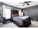 Stylish bedroom featuring a bold accent wall, carpet floors, and a comfortable bed at 4955 Day Lily Nw Way, Acworth, GA 30102