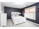 Bedroom with dark accent wall, white furniture and natural light from windows at 4955 Day Lily Nw Way, Acworth, GA 30102