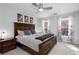 This bedroom features a wooden bed frame, neutral walls, artwork, and two windows for natural light at 4955 Day Lily Nw Way, Acworth, GA 30102