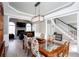 Spacious dining room showcasing a decorative light fixture, wood-look flooring, and views into the living room at 4955 Day Lily Nw Way, Acworth, GA 30102
