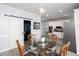 View of dining room table with barn door open to laundry room, and kitchen in the background at 4955 Day Lily Nw Way, Acworth, GA 30102