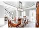 Bright dining room featuring a decorative light fixture, wainscoting, and views into other rooms at 4955 Day Lily Nw Way, Acworth, GA 30102