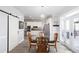 A lovely dining area adjacent to the kitchen with a glass table and sliding barn door at 4955 Day Lily Nw Way, Acworth, GA 30102