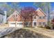 Beautiful two-story red brick house featuring an attached two car garage at 4955 Day Lily Nw Way, Acworth, GA 30102
