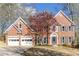 Charming brick home with a well-manicured lawn and attached two-car garage, and mature landscaping at 4955 Day Lily Nw Way, Acworth, GA 30102