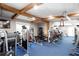 Bright home gym equipped with a range of equipment and a beamed ceiling for an inviting workout space at 4955 Day Lily Nw Way, Acworth, GA 30102