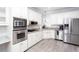 Kitchen with stainless steel appliances, white cabinetry, and modern finishes at 4955 Day Lily Nw Way, Acworth, GA 30102