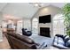 Comfortable living room with vaulted ceilings, a fireplace, large windows, and access to the kitchen and dining areas at 4955 Day Lily Nw Way, Acworth, GA 30102