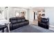 Living room boasts a large couch with views to the dining room and kitchen at 4955 Day Lily Nw Way, Acworth, GA 30102