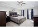 Main bedroom with tray ceiling, carpeted floors, and natural light through windows at 4955 Day Lily Nw Way, Acworth, GA 30102