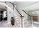 Elegant staircase with a combination of carpeted treads and a black and white banister at 4955 Day Lily Nw Way, Acworth, GA 30102